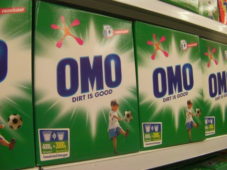 OMO detergent boxes with tag line "Dirt is good."